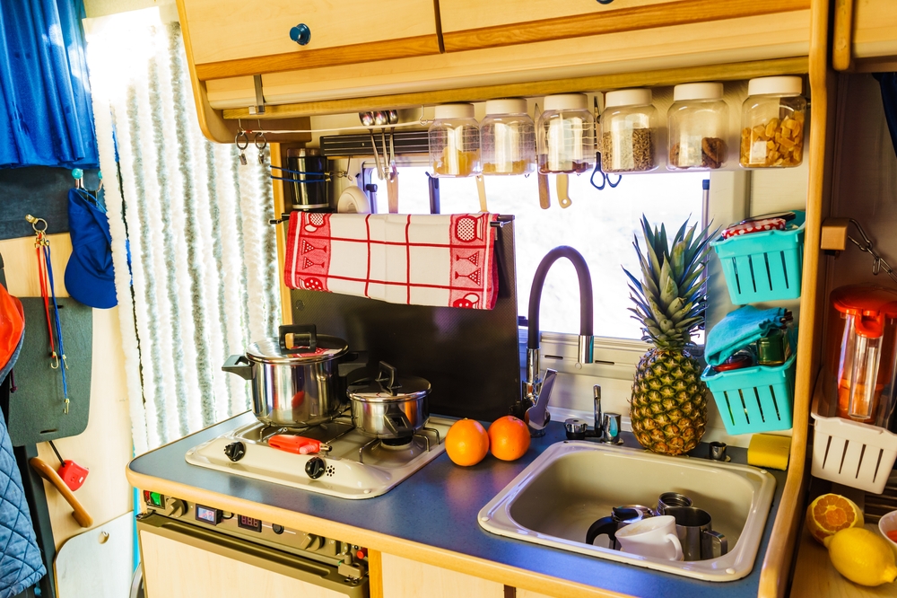 an RV kitchen with stove and dishes