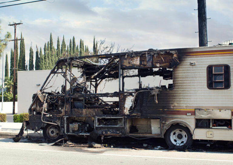 a blackened camper after a fire