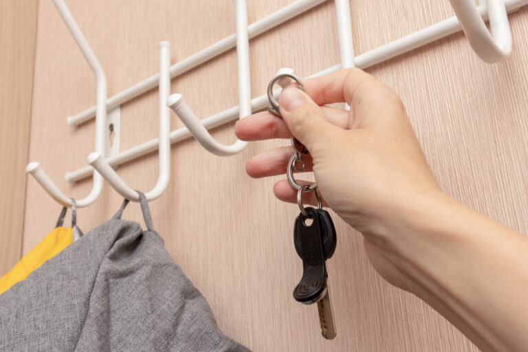 a person hanging keys on hooks