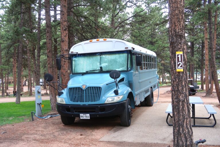 a blue school bus converted into a camper - Shutterstock