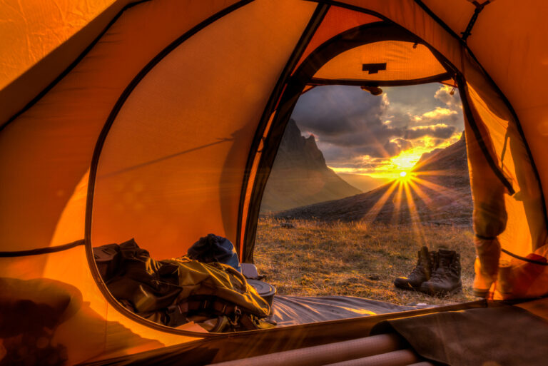 looking out a tent door at sunset