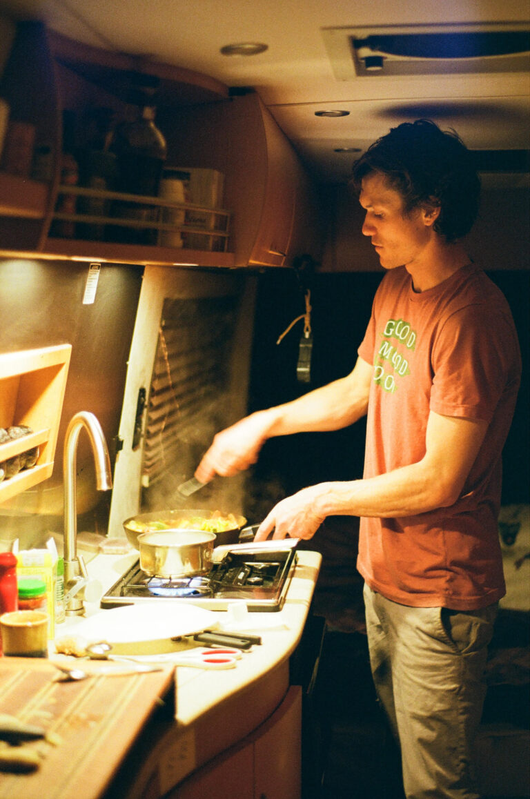 a man cooking on an RV stove