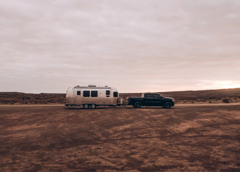 a pickup towing an airstream trailer