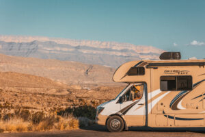 A woman in an RV in the desert