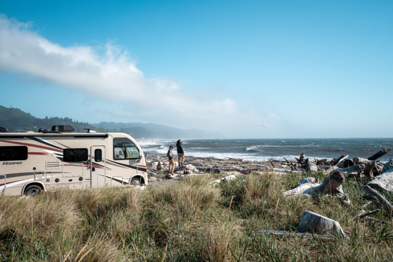 an RV parked by the shore