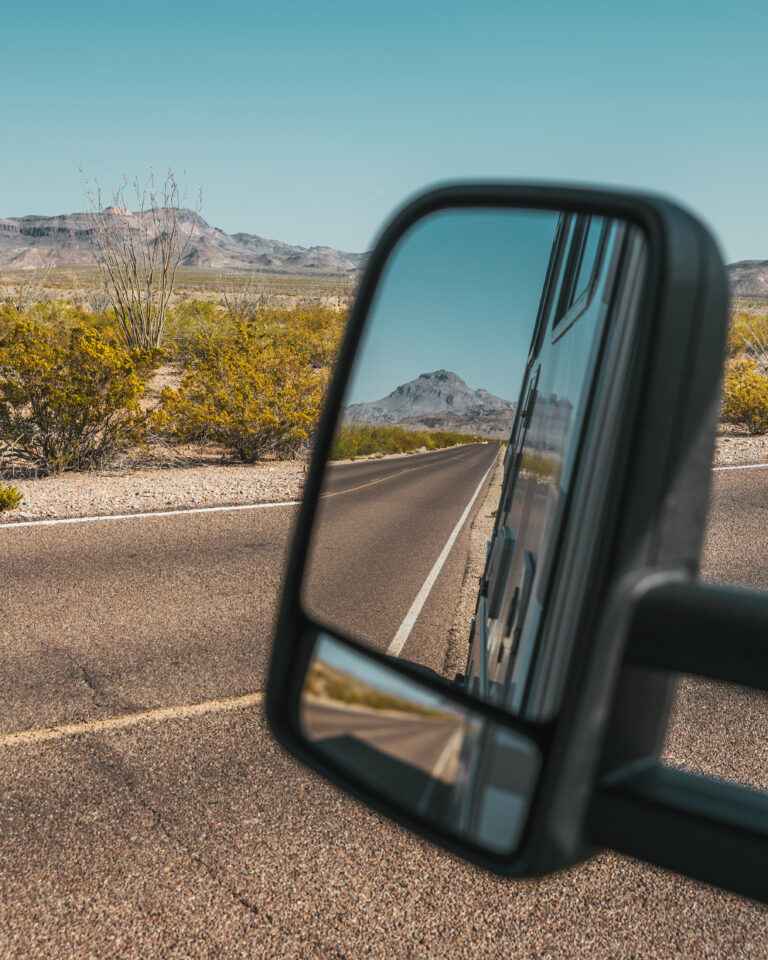 looking in an RV mirror at the road