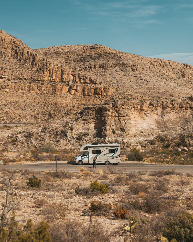 an RV by red rocks
