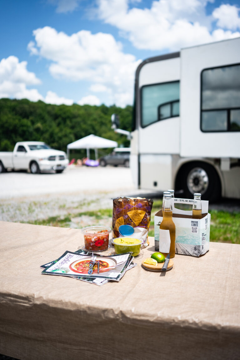 an RV next to a picnic table