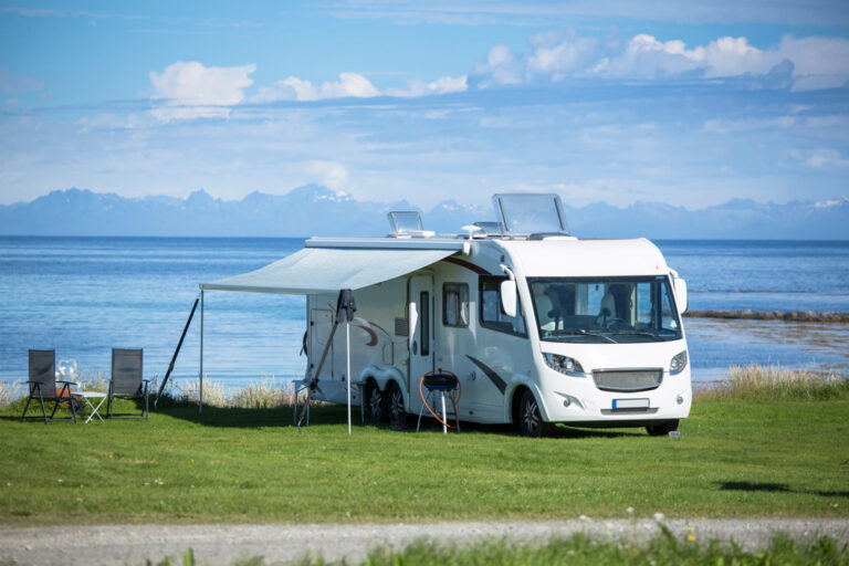 an RV awning set up by the water