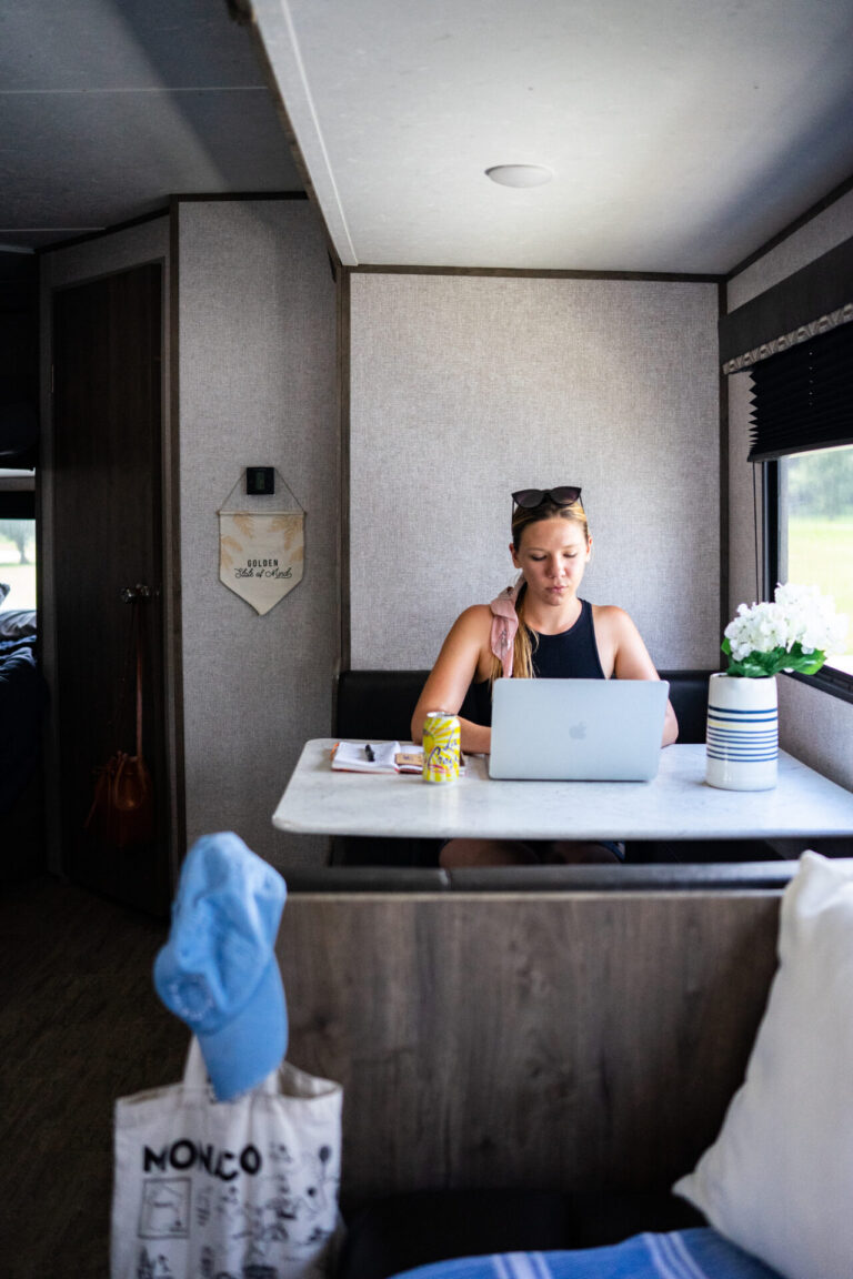A woman working at a computer in an RV