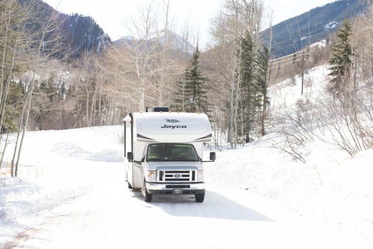 An RV driving in snow