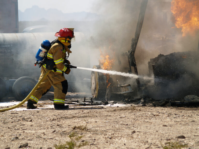 a fireman putting out an RV fire