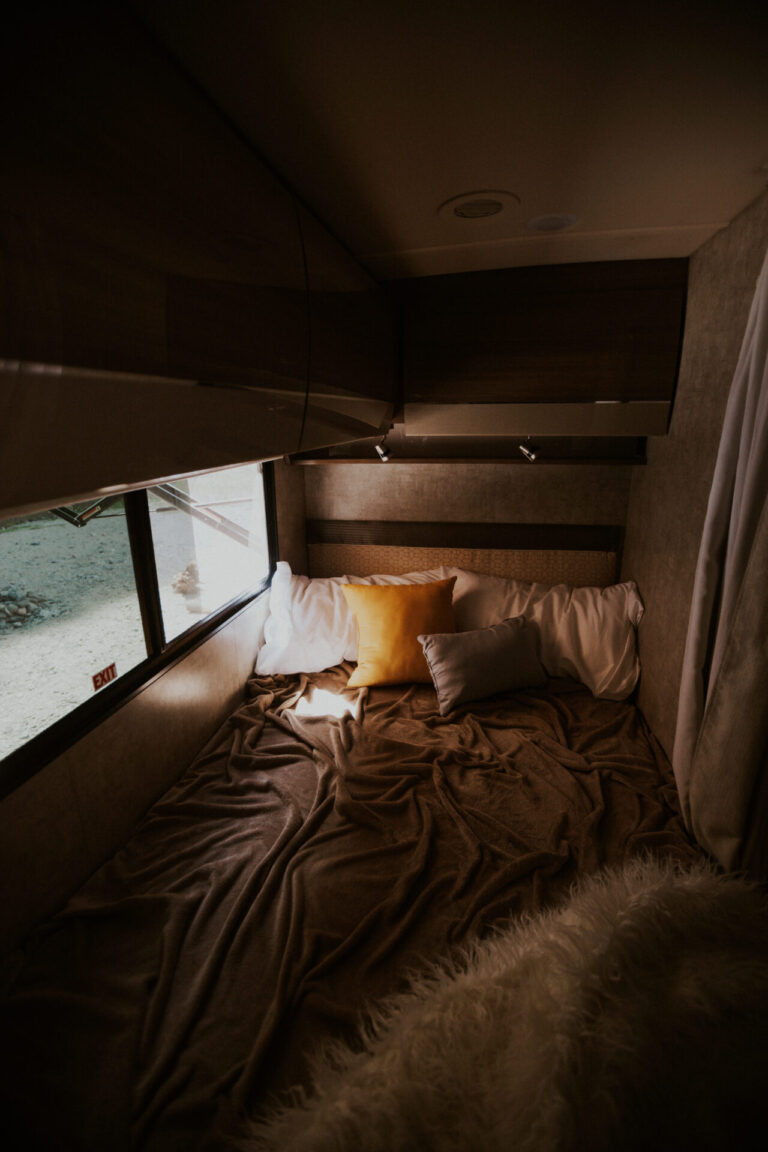 an RV bed with trendy bedding