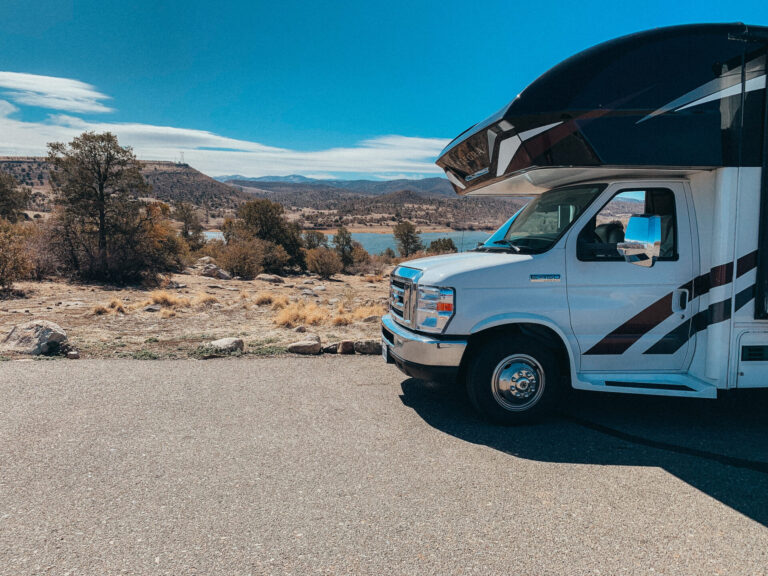 a camper in front of a lake