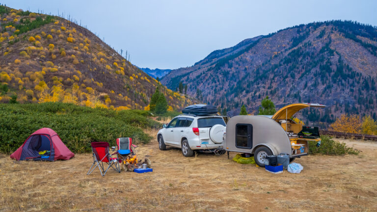 A teardop camper set up at a campsite