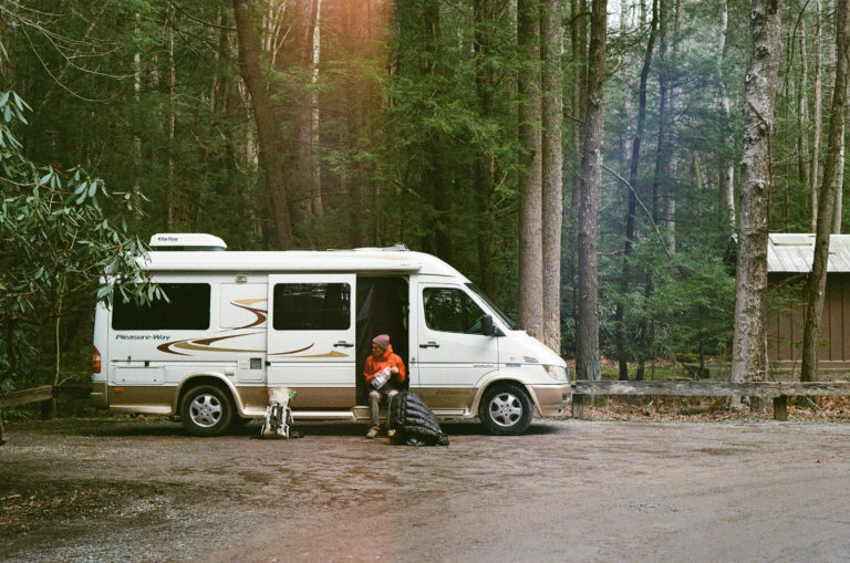 camper van parked in the middle of the woods