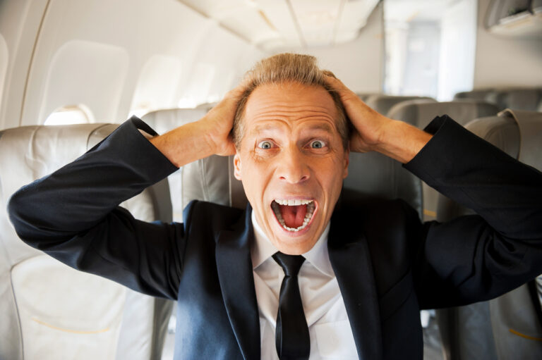 A man on a plane yelling in frustration