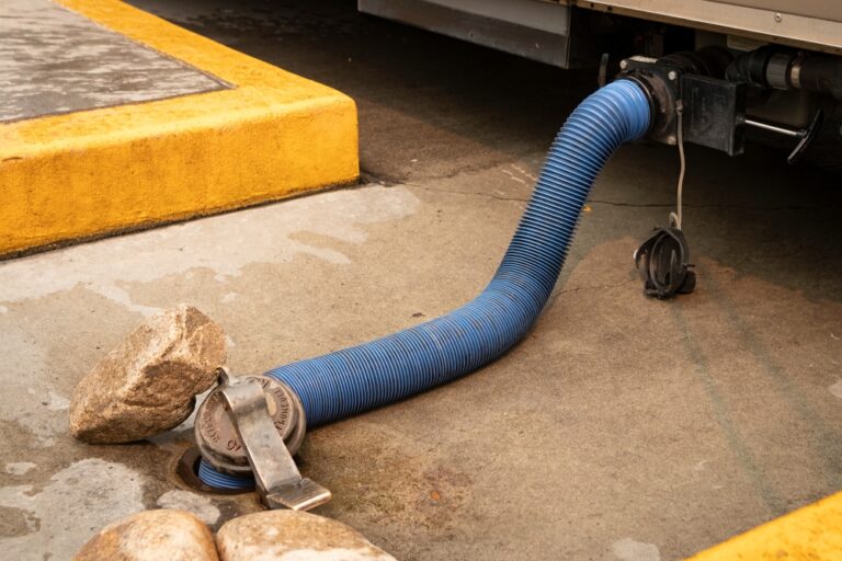 A hose stretching from RV holding tank to sewer