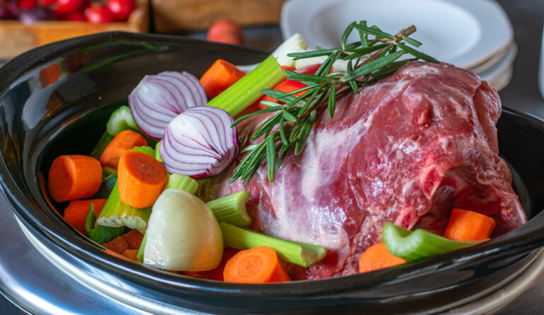 A slow cooker full of meat and vegetables