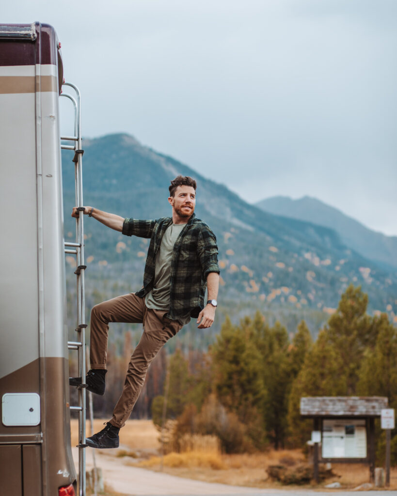 a man hanging from his RV ladder