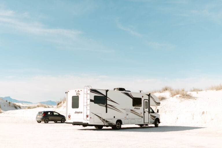 A Class C camper parked in a stark desert