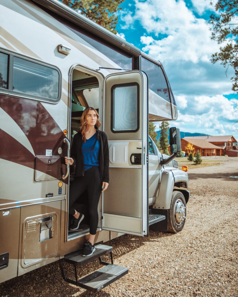 A woman standing in the door of her camper