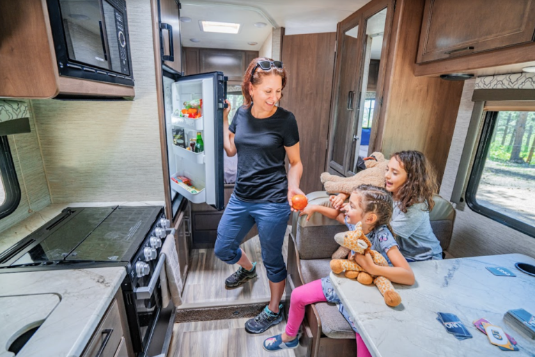 A mom opening an RV fridge