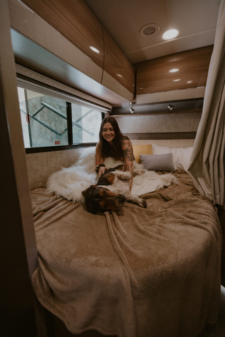 A woman with a dog on her RV bed