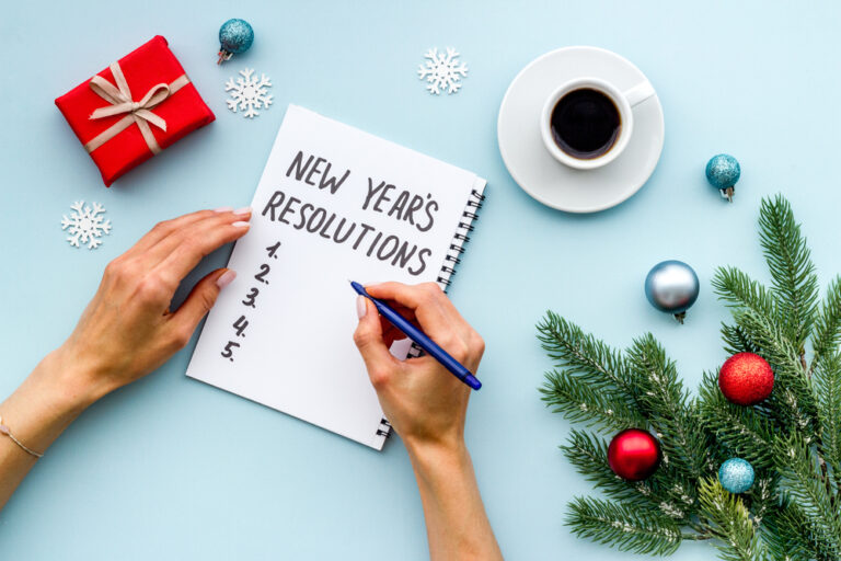 a person writing a list of New Year's resoutions
