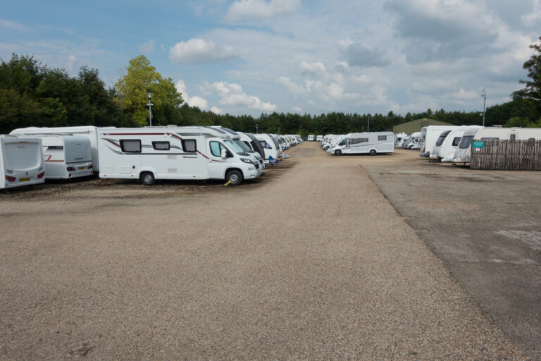 A row of RVs at a storage area