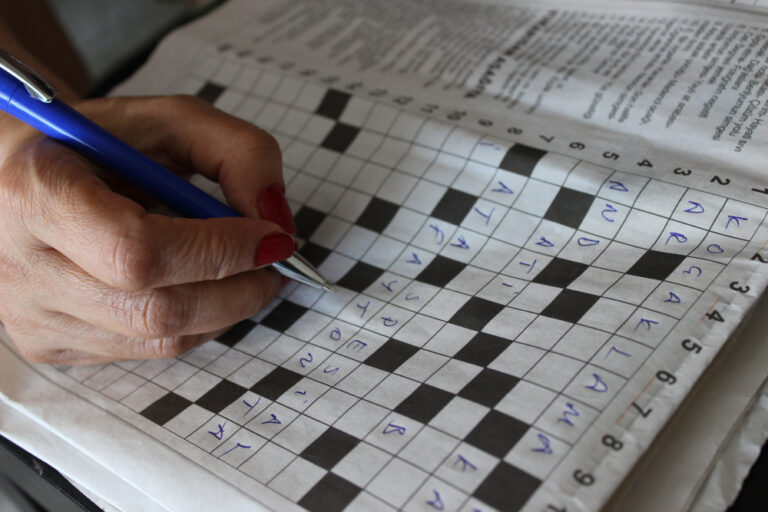 A person working a crossword puzzle