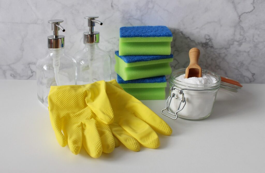 gloves, spray bottles, and other cleaning supplies