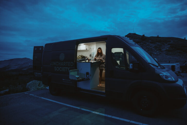 a woman at her stove in a campervan