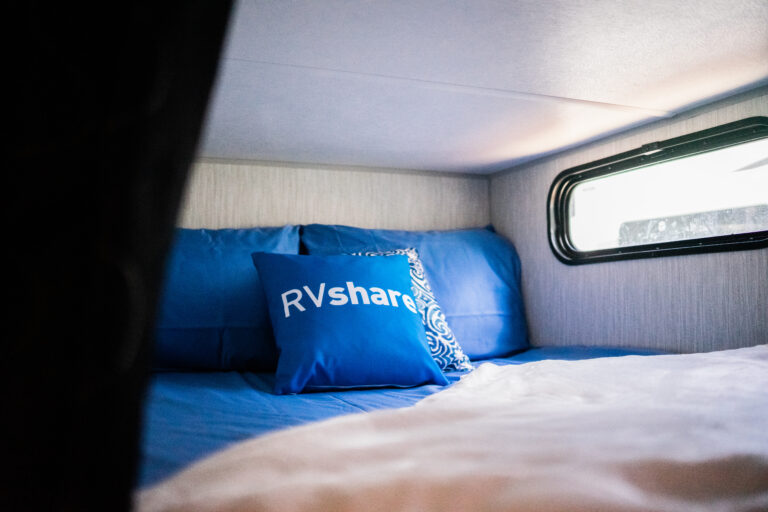 A motorhome bed with an RVshare pillow