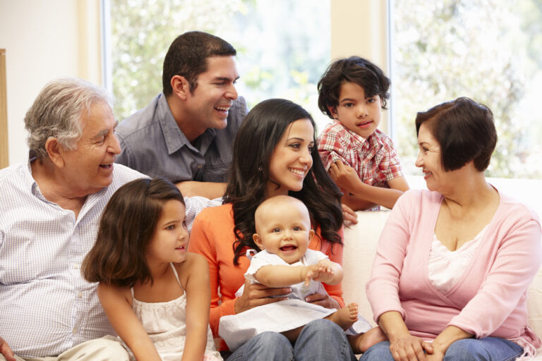 several generations of family smiling at each other