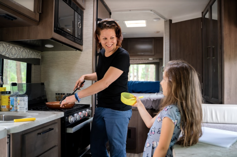 A woman cooking in an RV kitchen