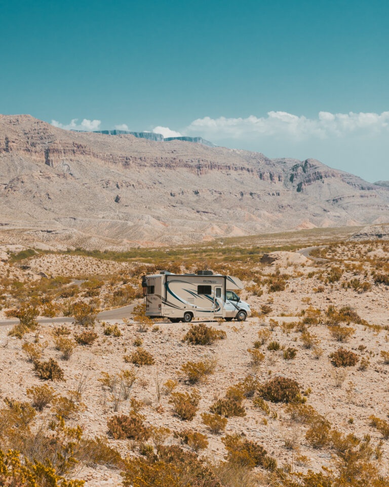An RV driving through the desert