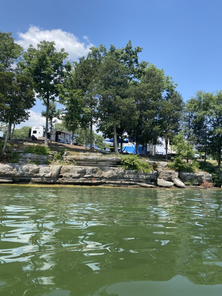 An RV in front of a lake