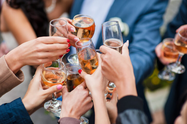 a group of wineglasses raised in toast