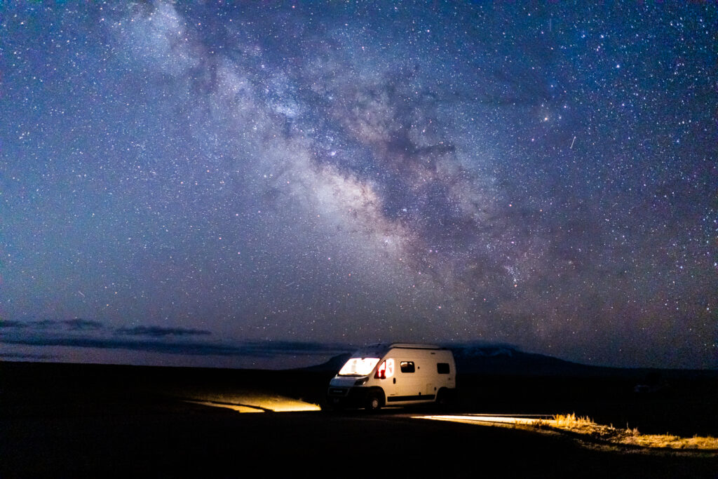 a campervan at night under a starry sky
