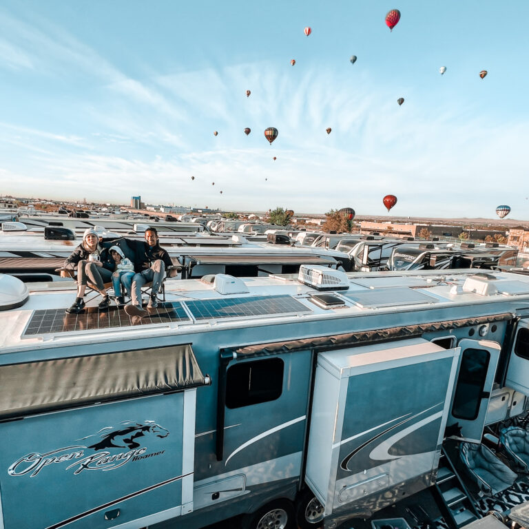 a family sitting on their RV roof