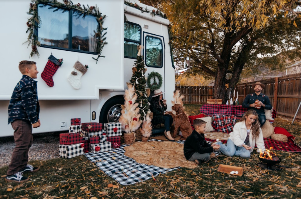a family in front of an RV decorated for Christmas