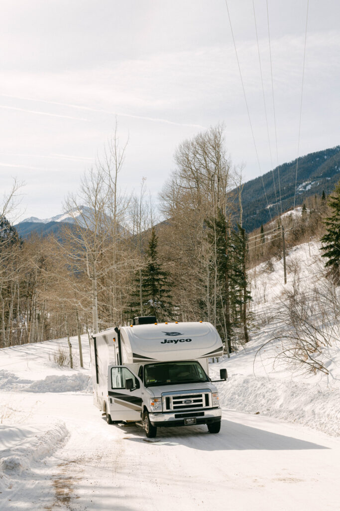 an RV driving in the snow