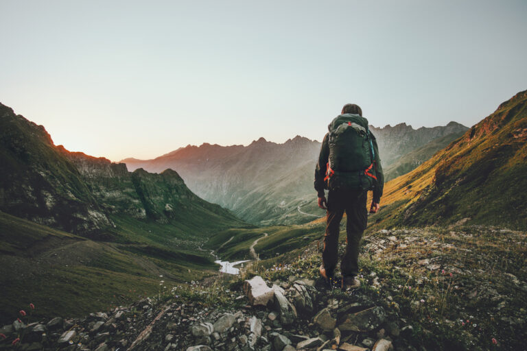 person with a backpack hiking in the mountains