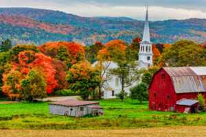 autumn foliage with a New England church and red barn