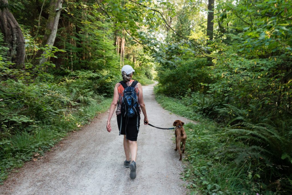 woman and dog on a hiking trail