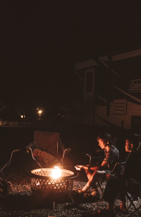 a family around a campfire at night