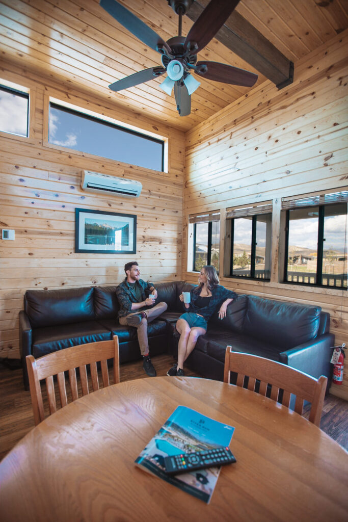 couple in a cabin enjoying coffee in the couch