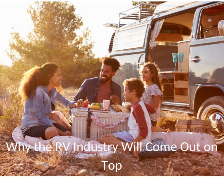 family enjoys picnic next to an RV