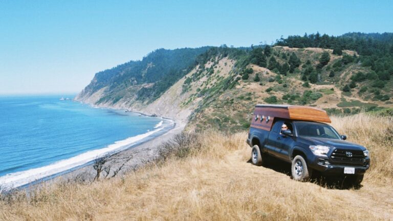 Custom truck camper driving near ocean